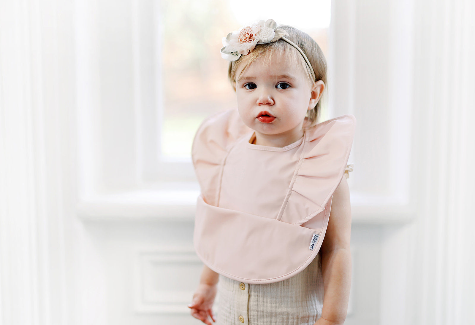 peach blush ruffle angel bib – certified baby safe &am | dropsona - neutral - close-up detail