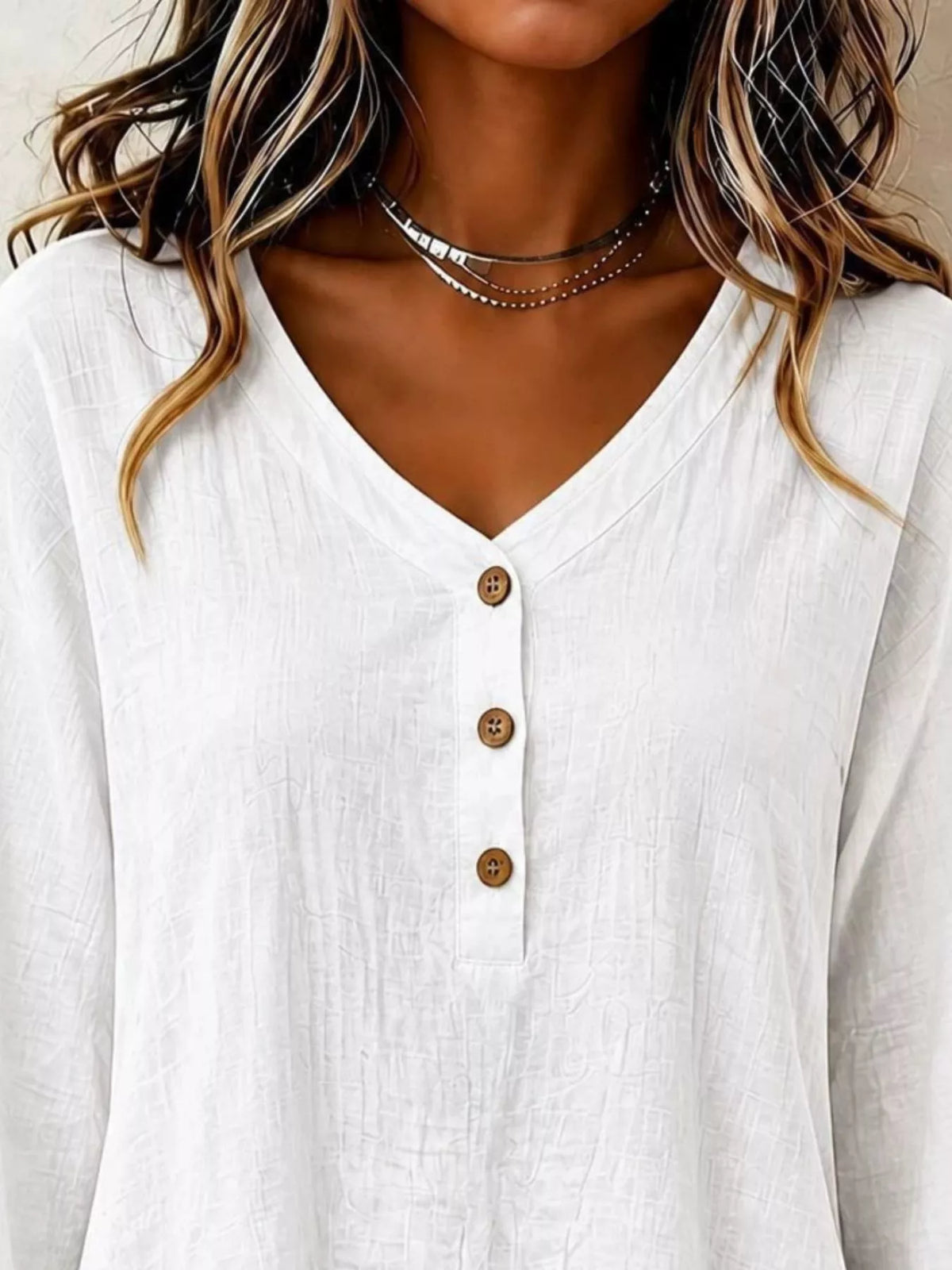 v-neck long sleeve button detail ruffled hem blouse | dropsona - neutral - front view