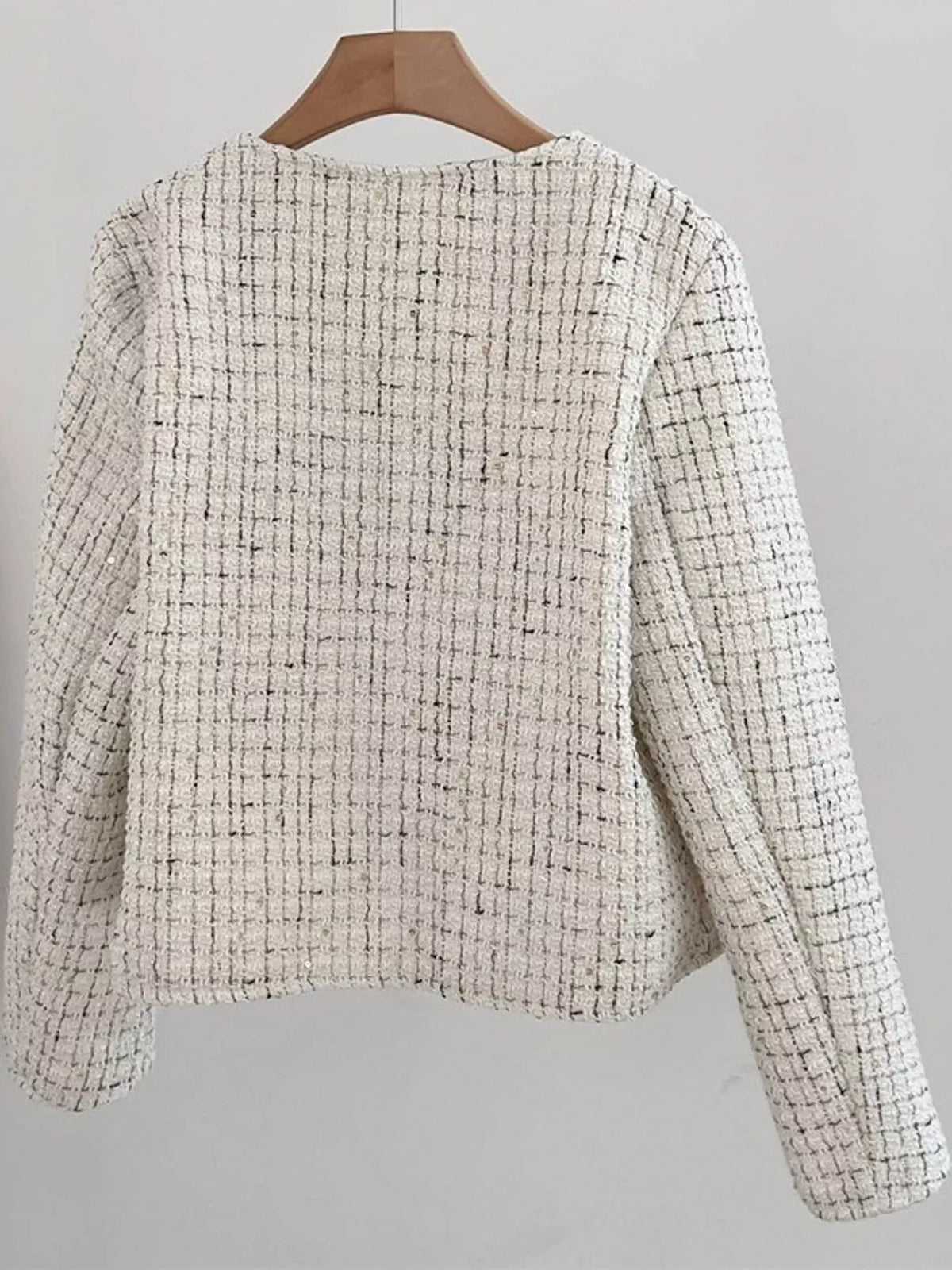 elegant tweed jacket with gold-tone button accents | dropsona - neutral - close-up detail