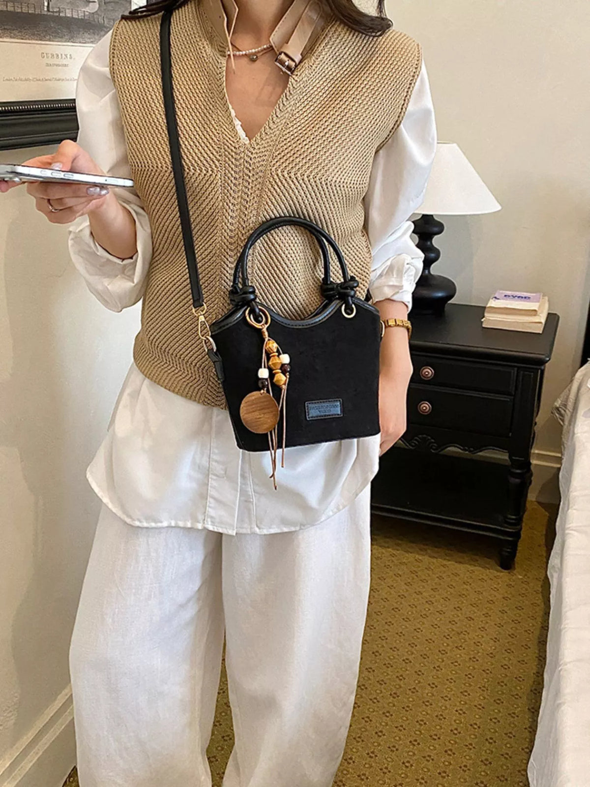 suede crossbody bag with decorative wooden bead charm | dropsona - neutral - front view