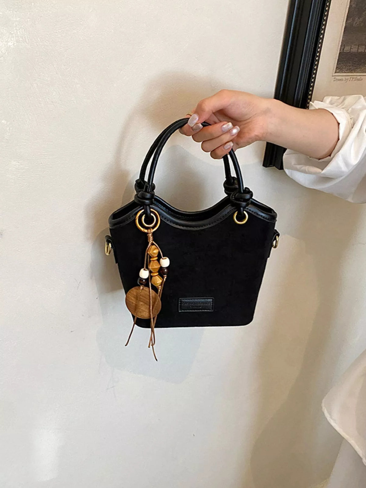 suede crossbody bag with decorative wooden bead charm | dropsona - neutral - usage example