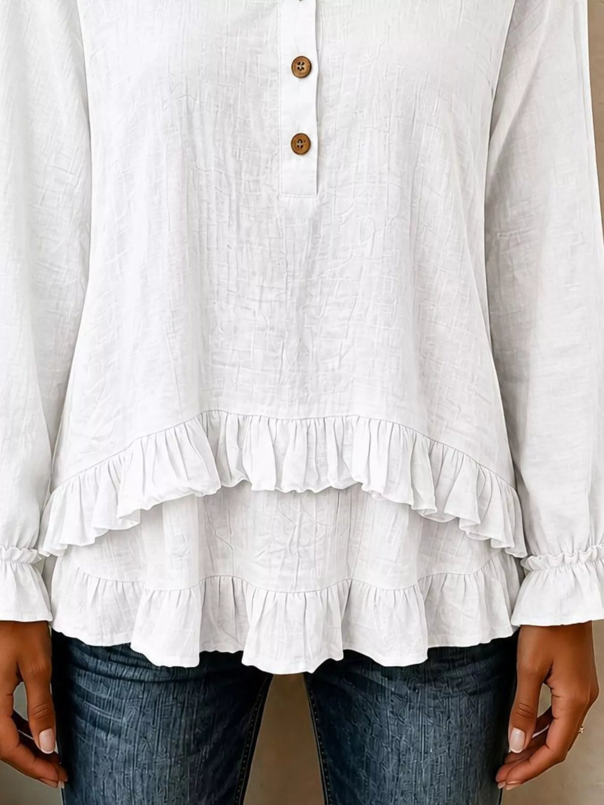 v-neck long sleeve button detail ruffled hem blouse | dropsona - neutral - close-up detail