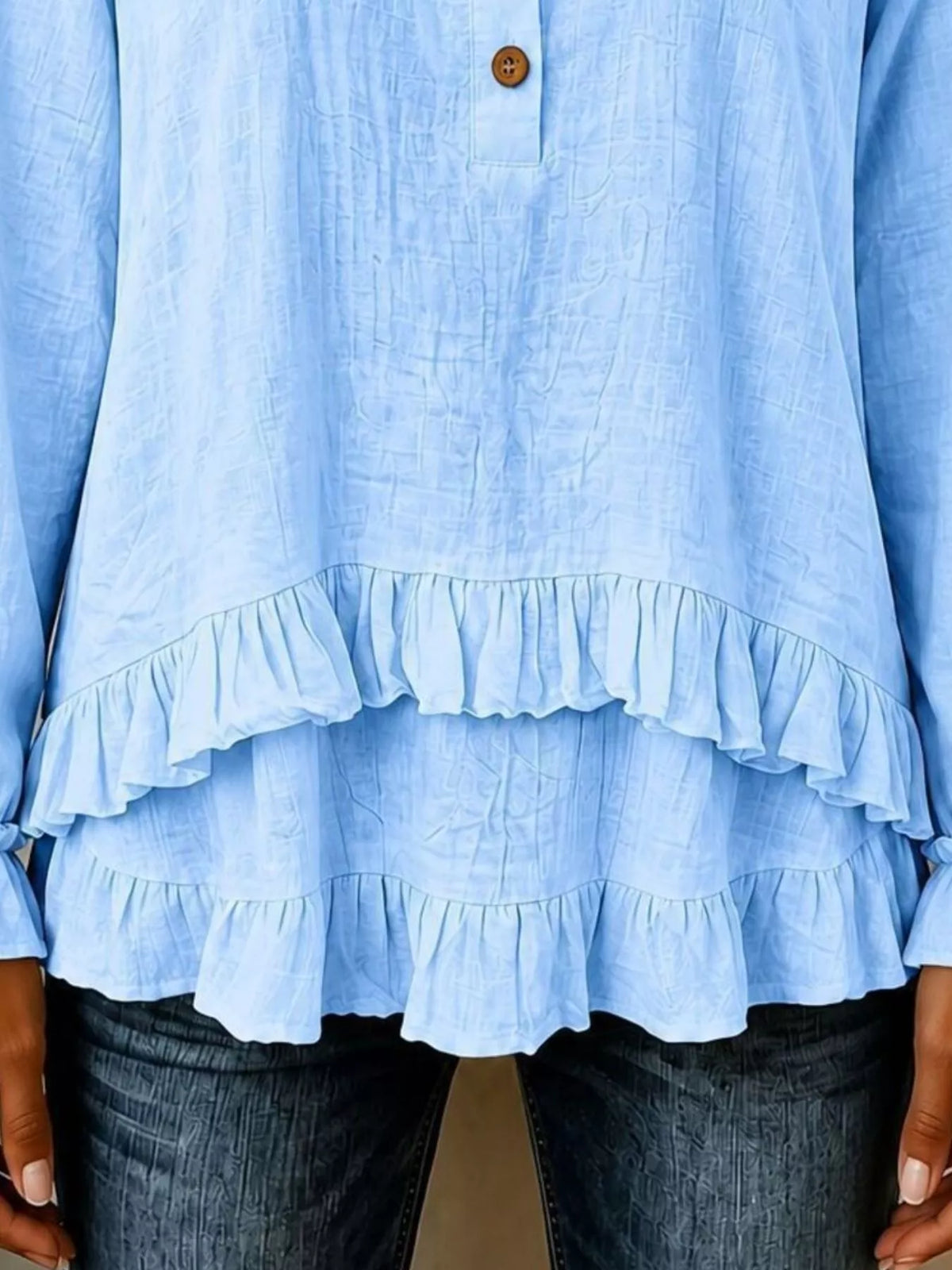 v-neck long sleeve button detail ruffled hem blouse | dropsona - neutral - close-up detail